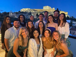 MBA students join for a picture at dinner outside the Acropolis in Athens 2023