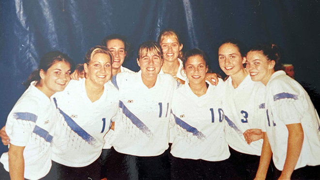 A photo of Kelly Scafariello and the RWU women's volleyball team in 1998.