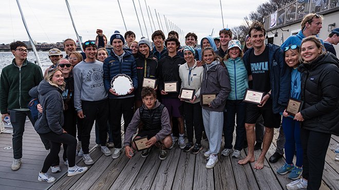 The RWU Sailing Team posing for a photo on a dock 