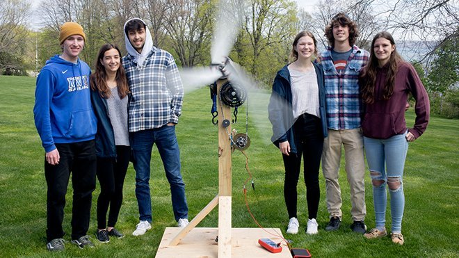Six Engineering students standing with their wind turbine project. 