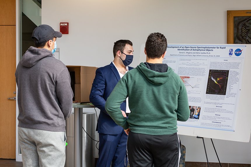 Students view physics poster