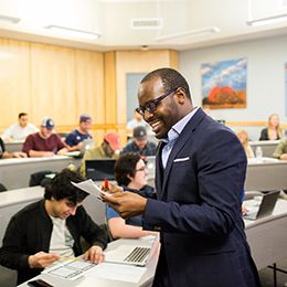 Professor smiles in front of class