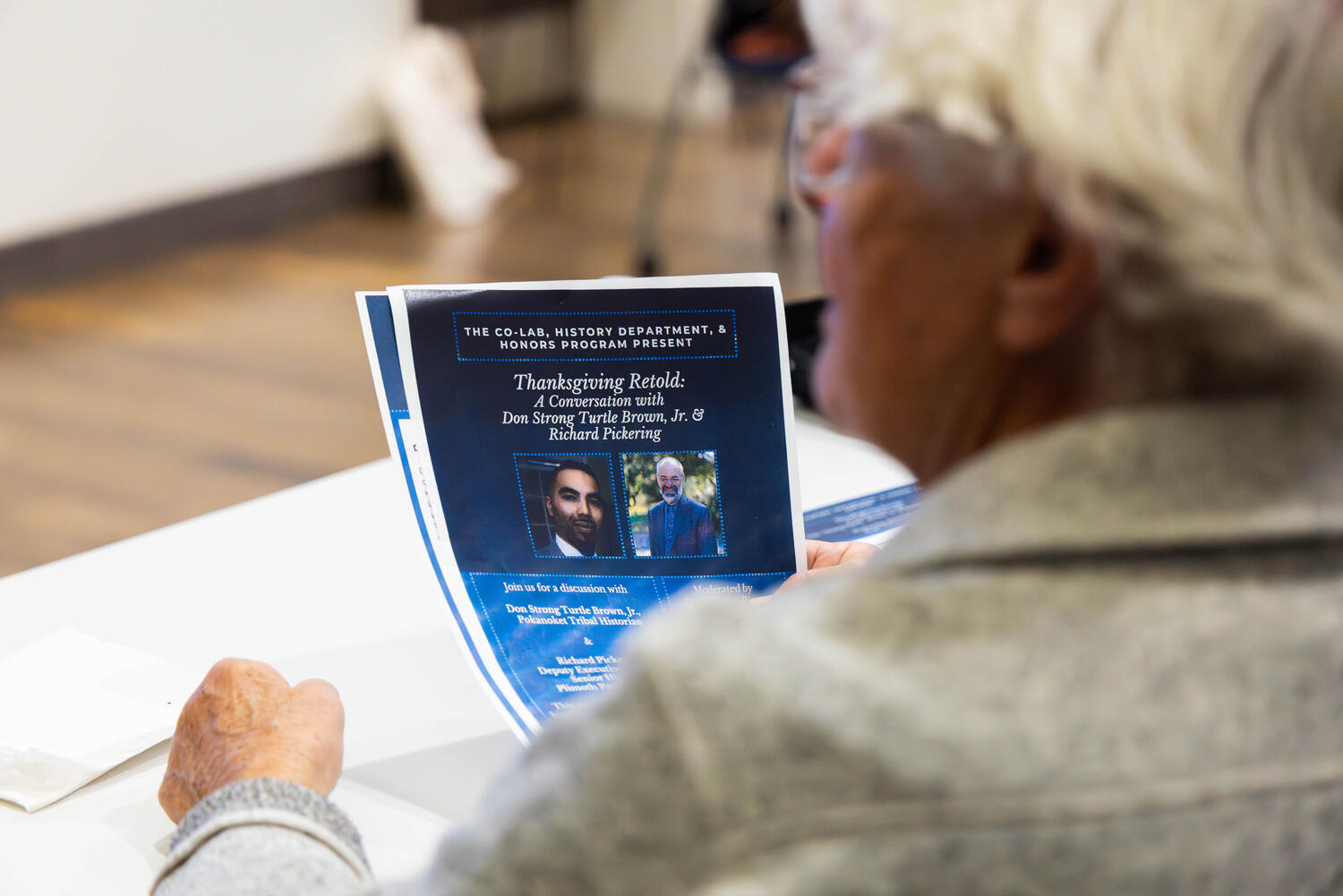 An attendee looks over the event flyer.