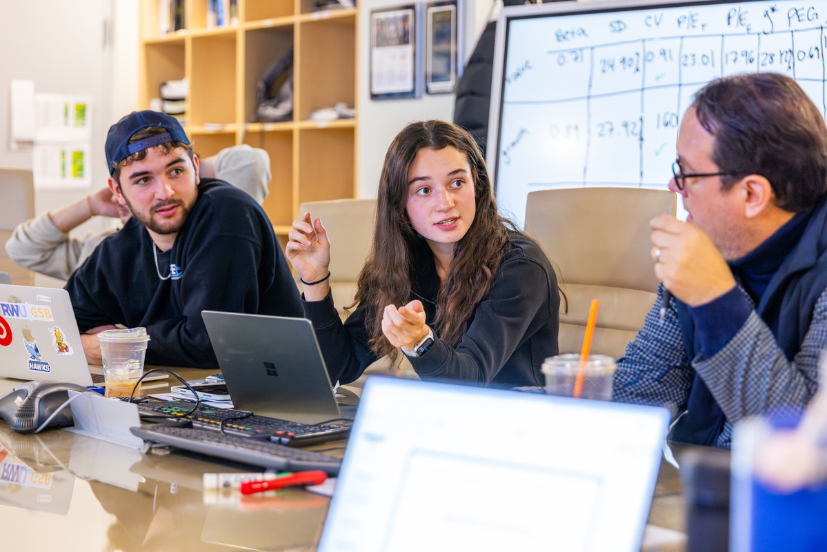 Chelsea King leads a CAFE meeting alongside Finance Professor Michael Melton, gaining hands-on experience managing real investment portfolios.