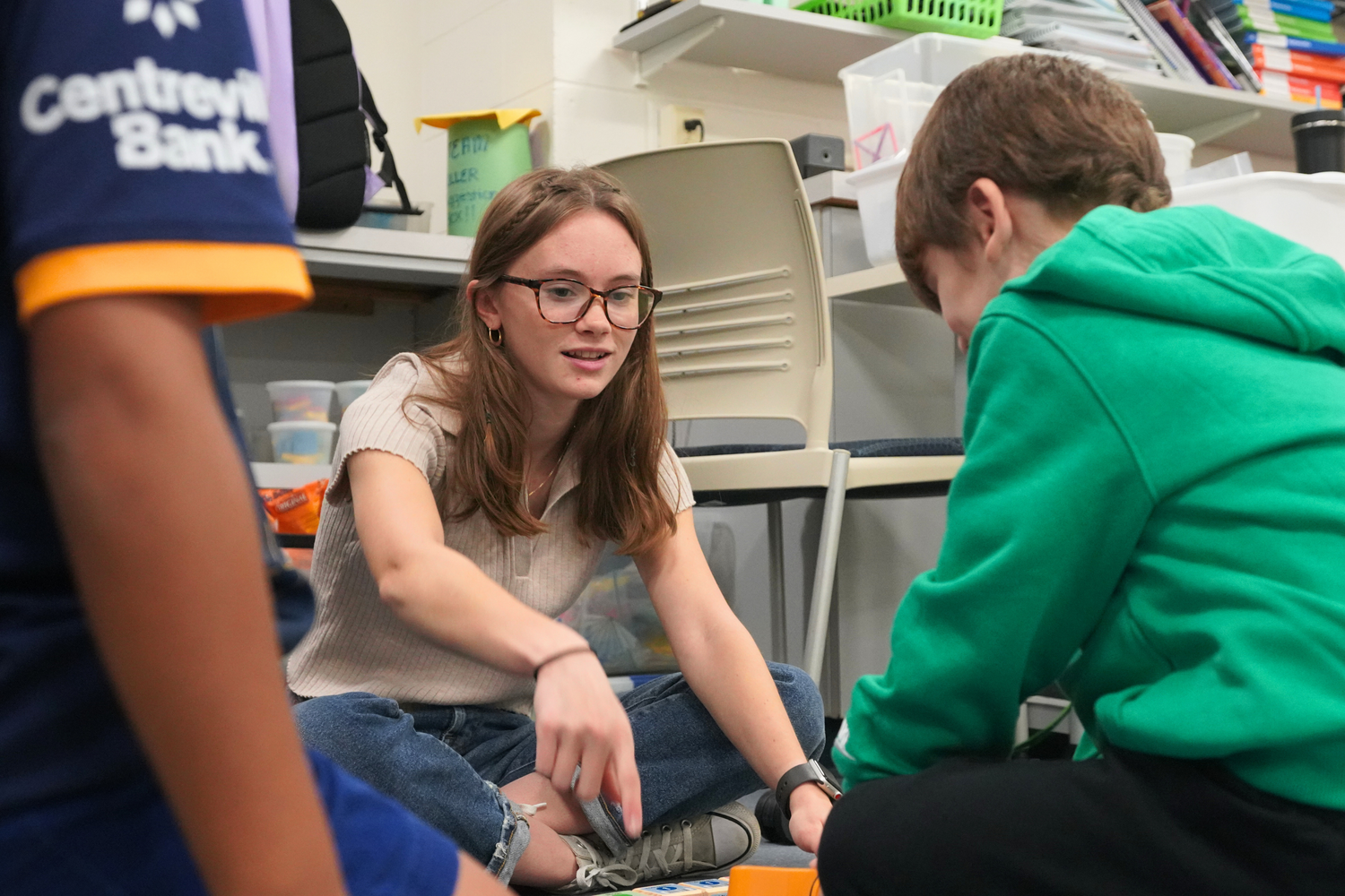 Junior Madison Nash encourages a Croft School second grader to try a new approach.