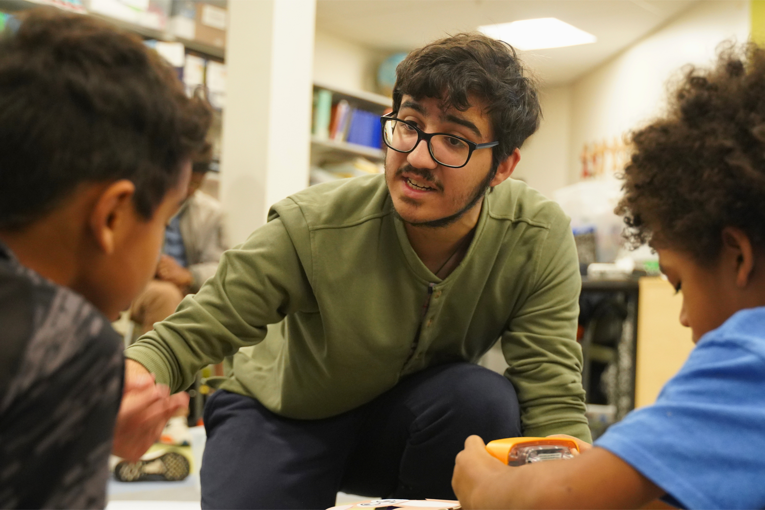 Sophomore Sebastian Cruz works one-on-one with Croft School students.
