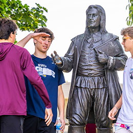 Students greet the Roger Williams statue