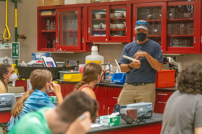 Brian Wysor works with high school students in the lab as part of a Marine Biology summer camp at RWU.