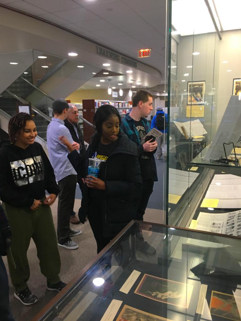 Students explore the library exhibition.