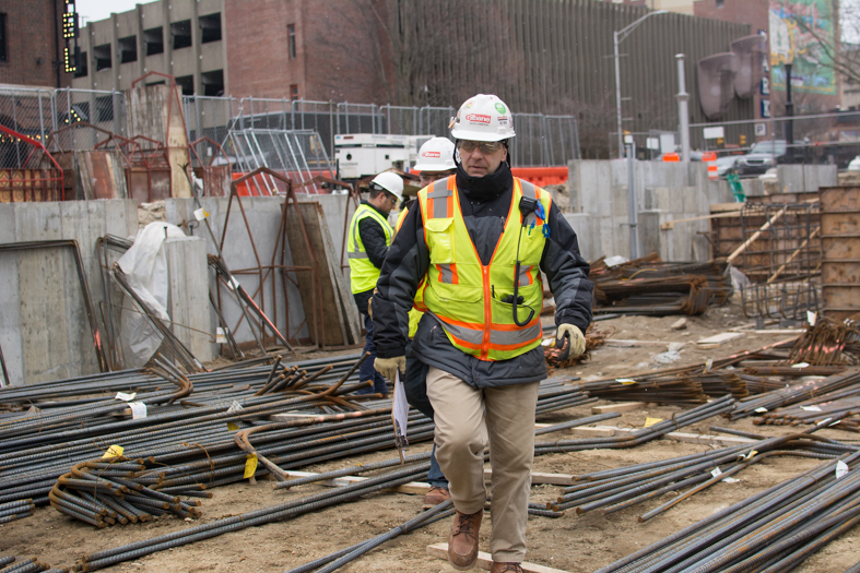 Cameron walks across construction site