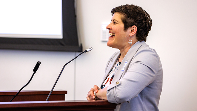Elaine Stiles smiling at a podium