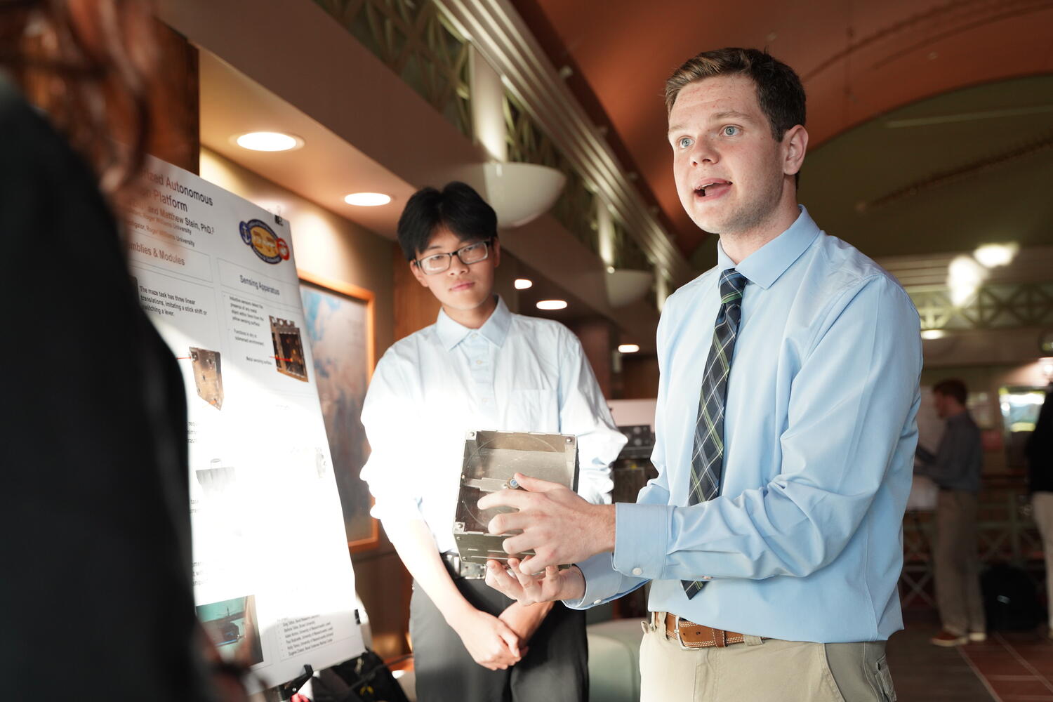 1. Seniors Chace Kirwan and Louis Zhu demonstrate their underwater robotics research for fellow students at the Summer Research Showcase.
