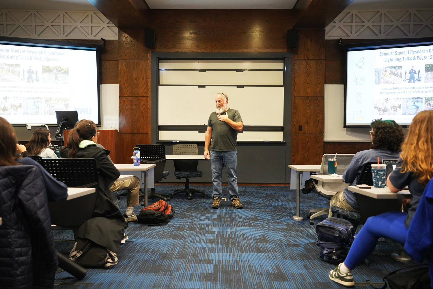 Adjunct Professor of Biology Jim Lemire welcomes a full house as he kicks off the annual Summer Research Showcase.