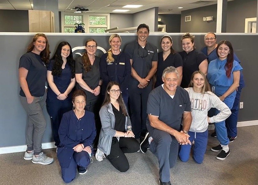Eden Ladouceur poses for a photo alongside her colleagues at Rhode Island Children's Dentistry & Orthodontics.