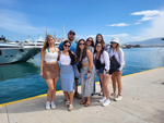 MBA students stand together on the waterfront in Athens 2023