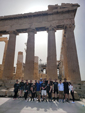 MBA students stand next to the Acropolis in Athens