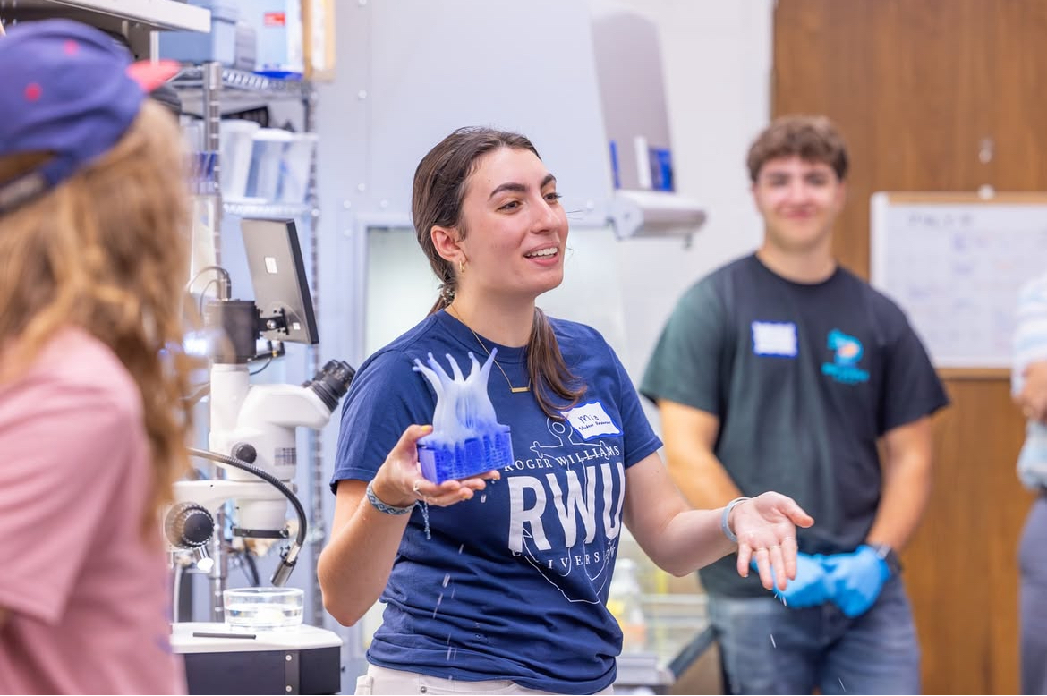 Mia Sarris demonstrates coral modeling using a 3D-printed replica of Astrangia poculata.