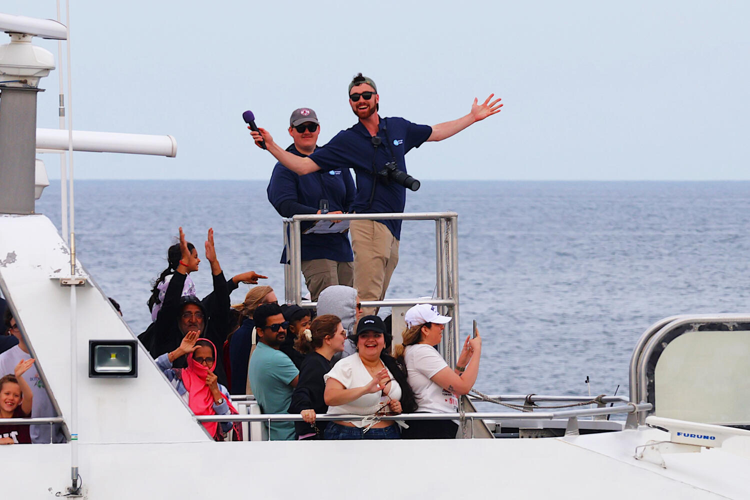 Junior Aiden Perham captures the action aboard a research vessel, documenting marine life and sharing insights with participants.