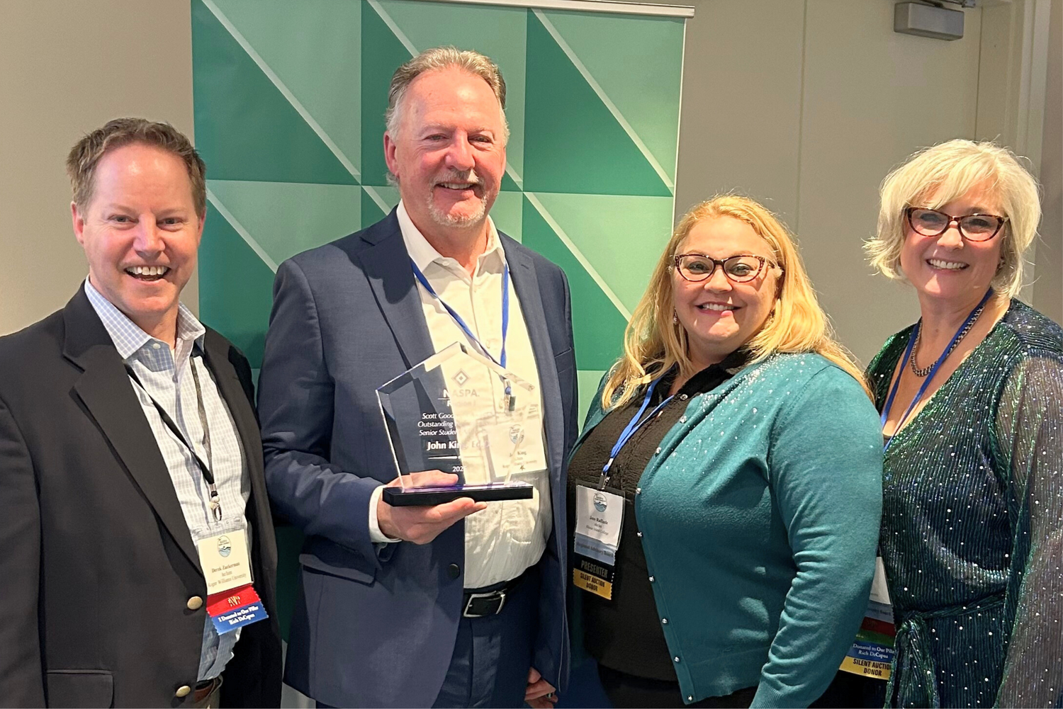 John King celebrates Region I's Scott Goodnight Award alongside Associate Vice President for Student Life and Dean of Students Derek Zuckerman.