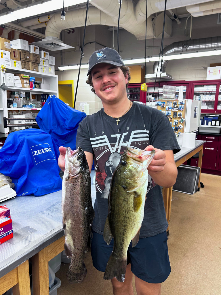 Michael Natoli holds up two fish in the Wet Labs.