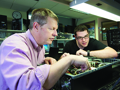 A professor and student in the Forensics and Networking Security lab