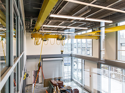 A yellow overhead crane in the construction management lab