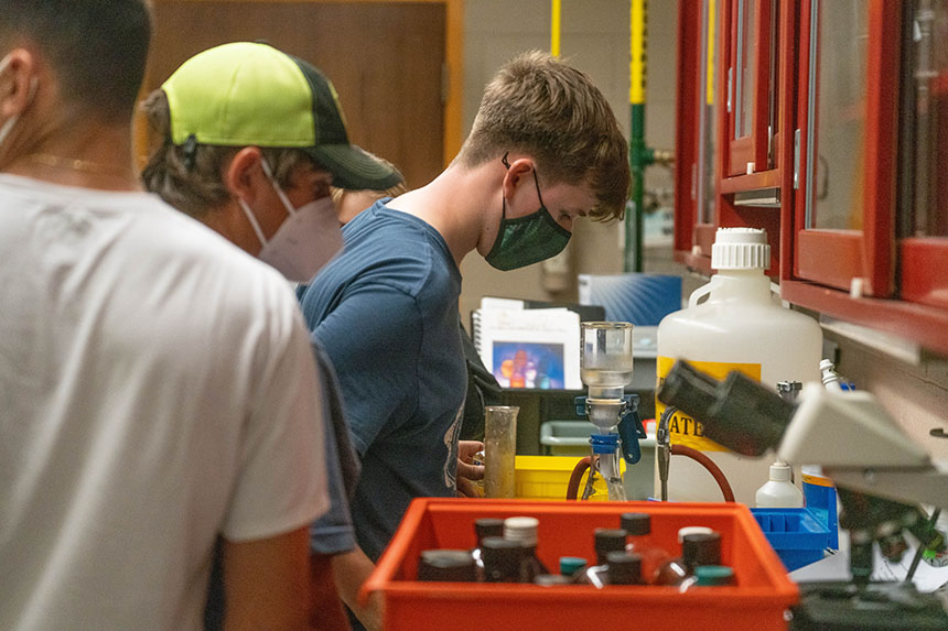A high school student in a Biology lab in the Marine and Natural Sciences building.