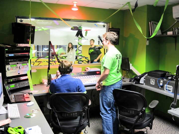 Students celebrate WQRI’s 2011 relaunch at the “WQRI Is Back” party, marking the station’s return following a major equipment failure and rebuild.