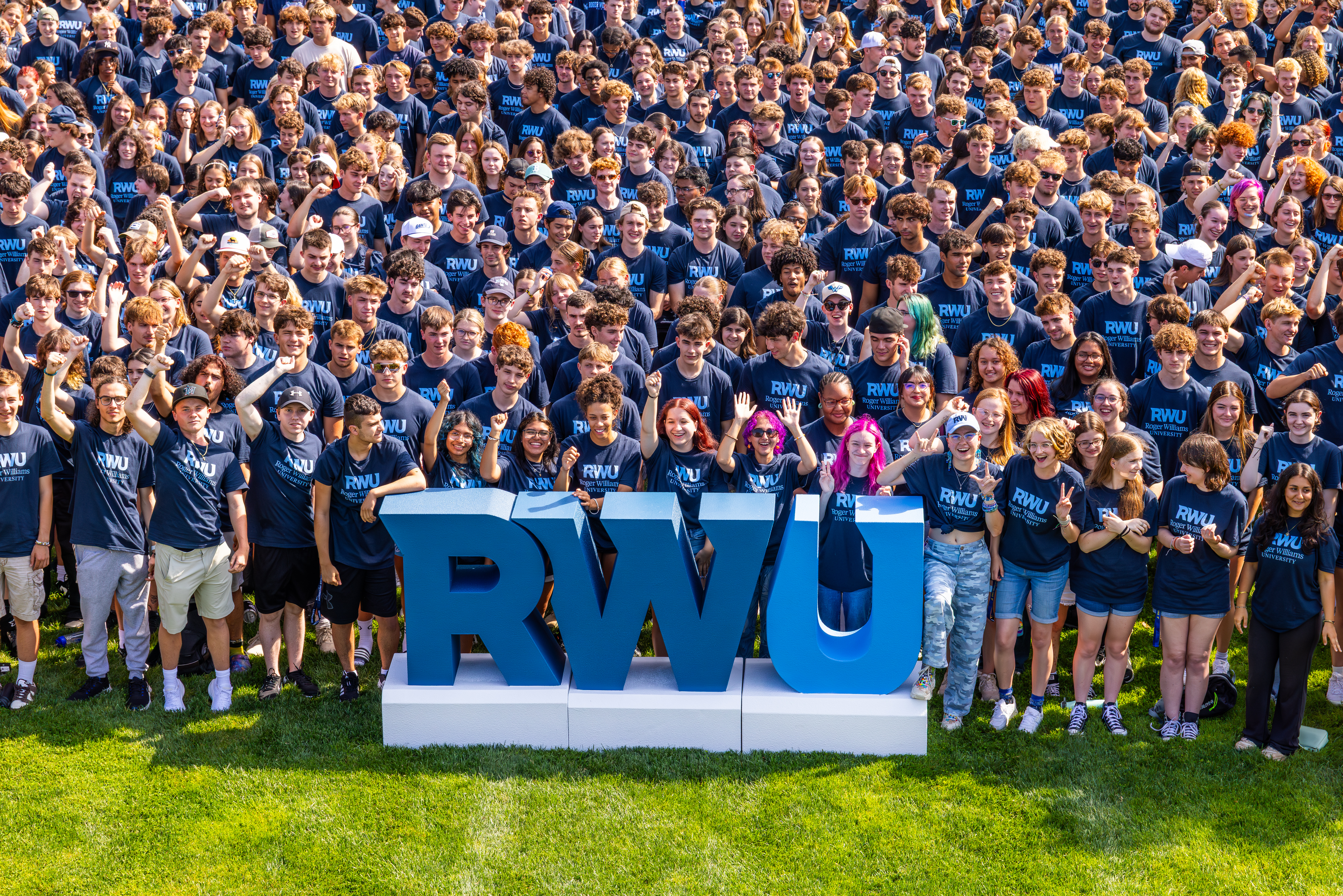 Group of students posing with RWU sign