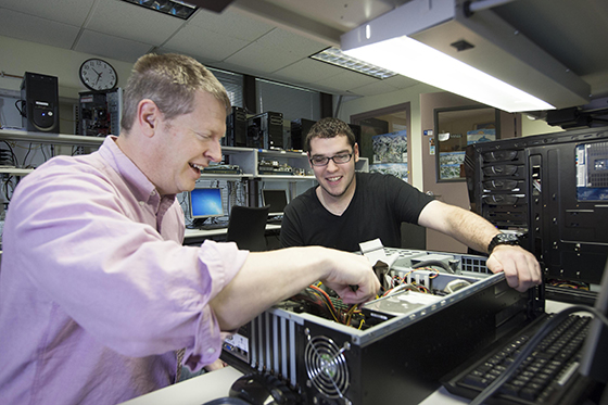Professor and student building computer.