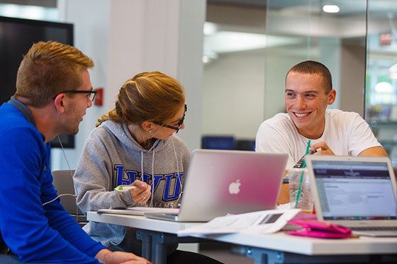 Students conversing in classroom.