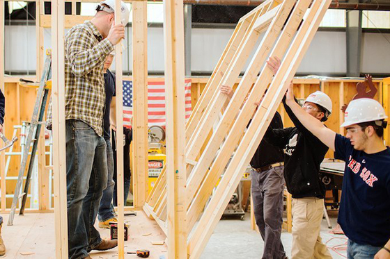 image of Construction Management students erecting a structure in wood 