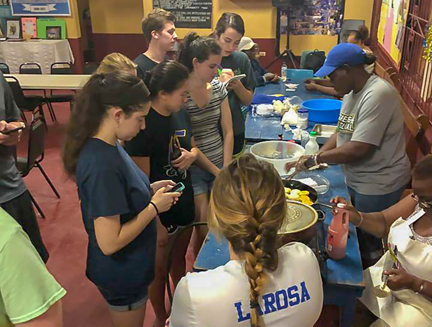 RWU students learning to make Jamaican dish
