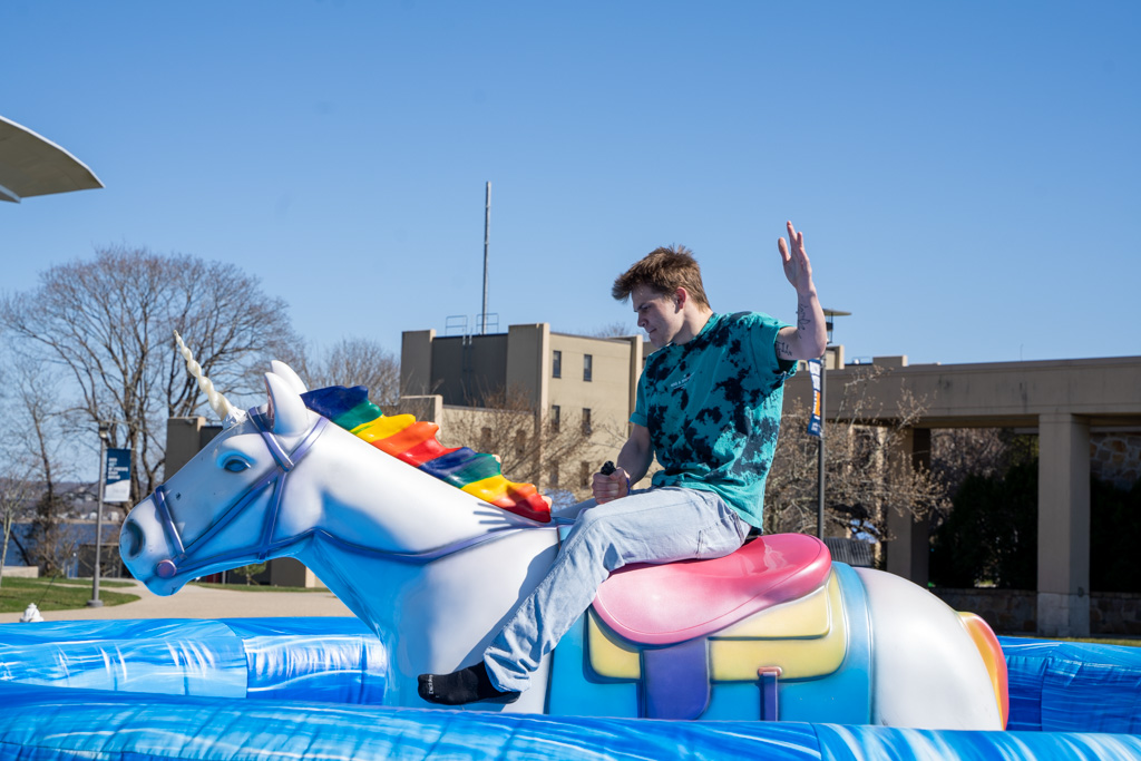 Student rides a mechanical unicorn
