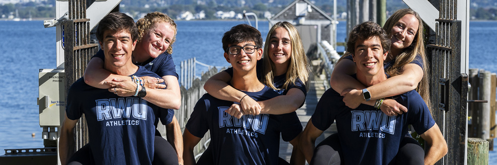 Students give each other piggy back rides at the waterfront 