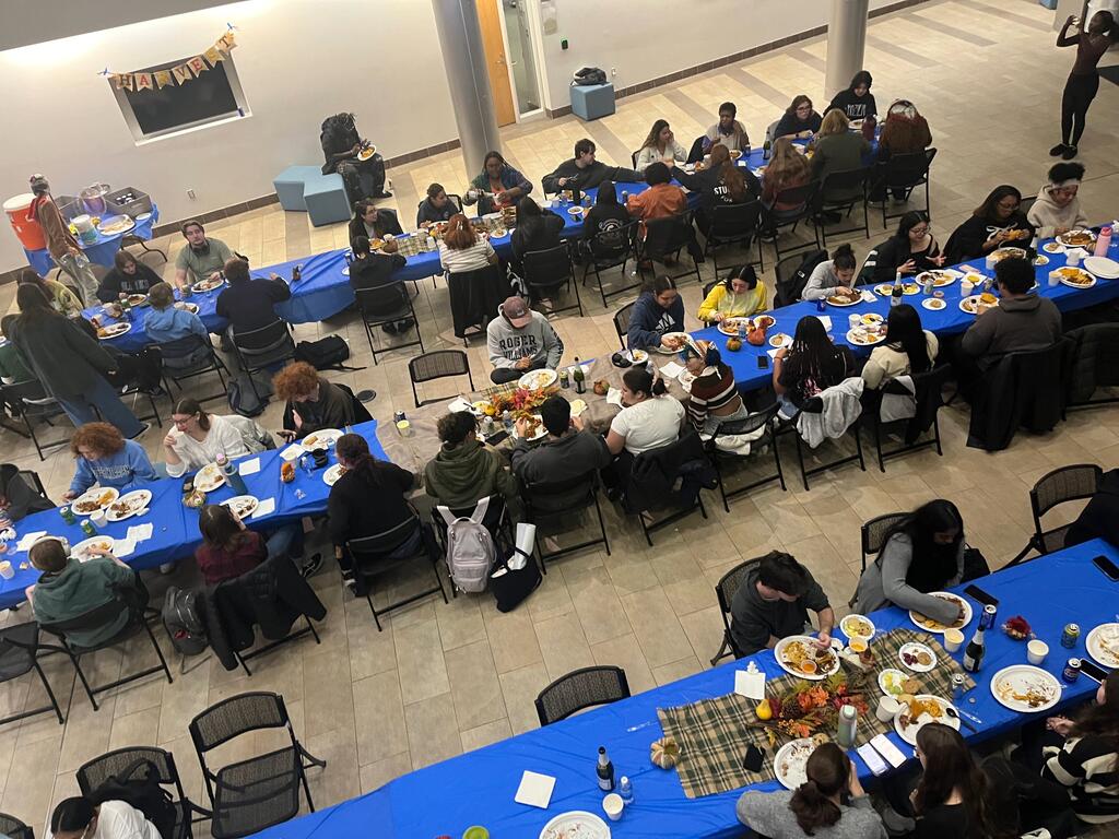 Students gathered around tables at Friendsgiving