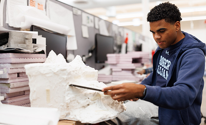 An architecture student sculpts a model