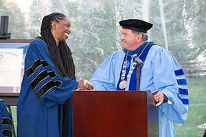 President Miaoulis shakes hands with honorary degree recipient Dr. Nicole Alexander-Scott at commencement