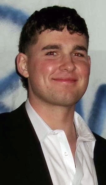 Nolan Niziol wearing a whit shirt and black suit jacket