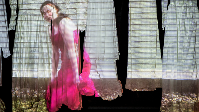 Projection of dancer in pink dress