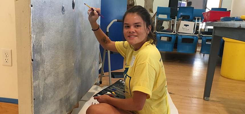 Student paints a wall