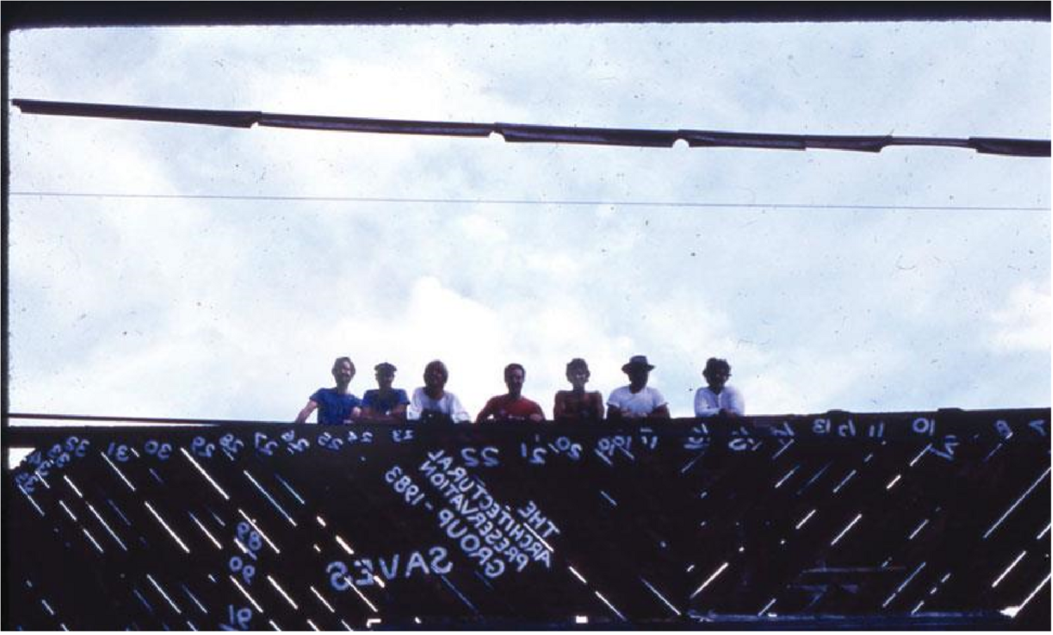The 1983 architectural preservation group working on reassembling the barn