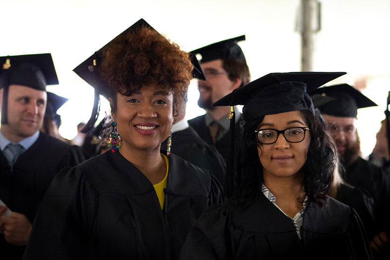 Graduates prepare to receive degrees.