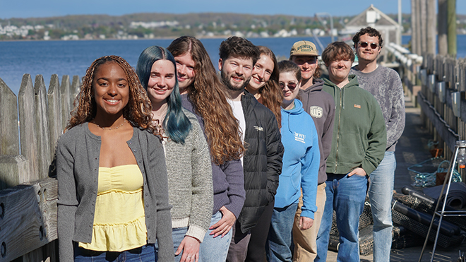 Blue Fellows stand on RWU's learning dock.