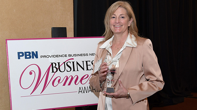 Laura Baldwin holds an award.