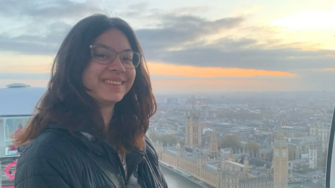 Aelan Lee smiling over a skyline view of London