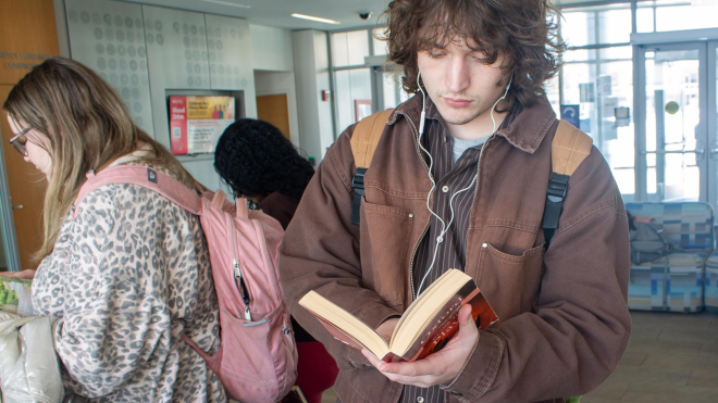 Student looking at book