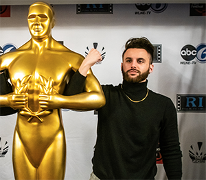 Nick Stanglewicz poses with life-sized Emmy award