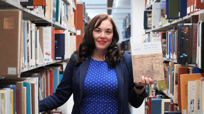 RWU History Professor Charlotte Carrington-Farmer holds her new book.