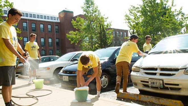 Students wash cars for residents of an independent living facility.